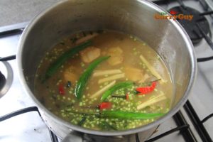 Adding vegetables to Thai soup