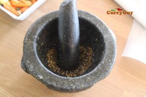 grinding mustard seeds and peppercorns