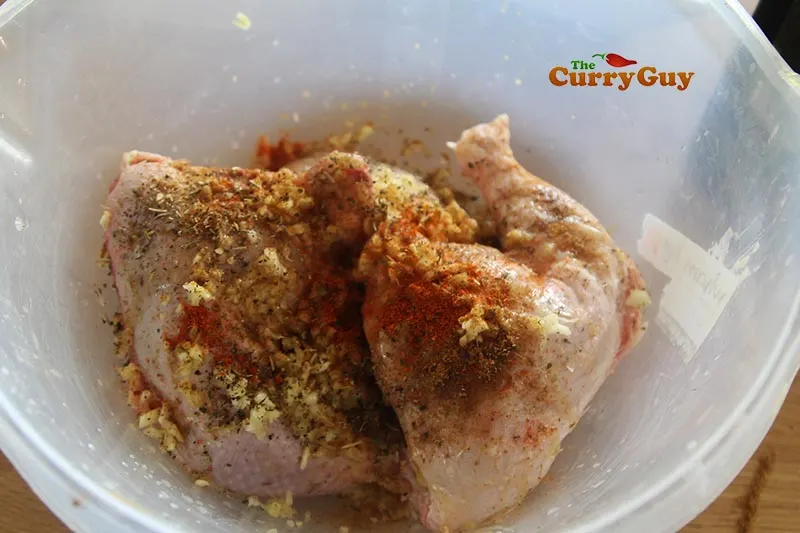 adding marinade ingredient to chicken