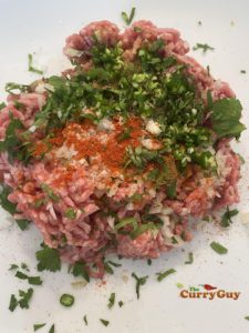 Adding ingredients to minced lamb
