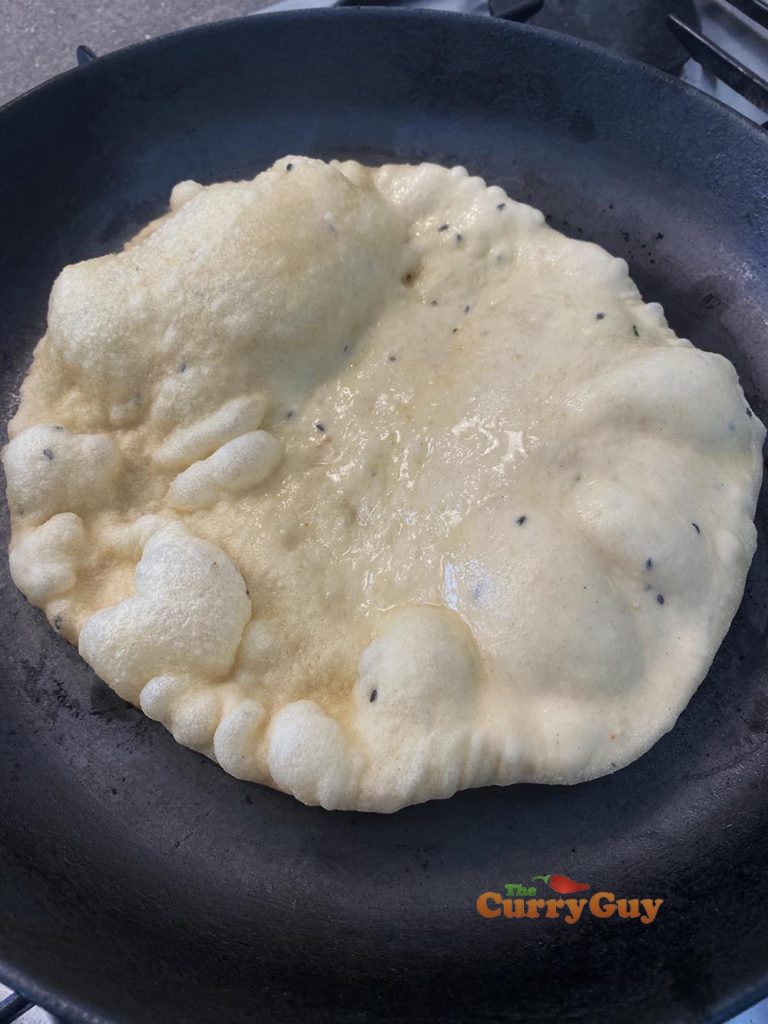 naan bubbling in a pan