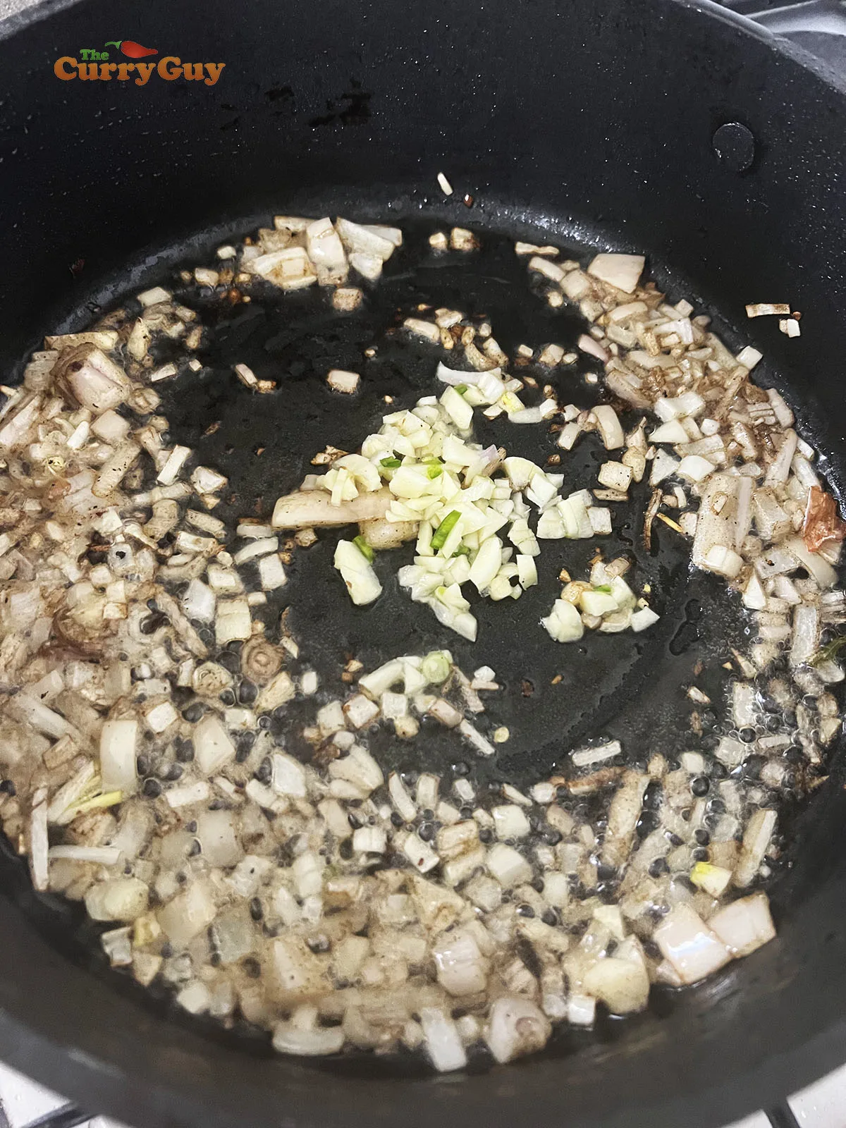 Frying onion and garlic for the sauce.