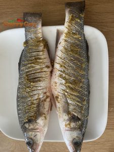 Sea bass covered in the green curry paste marinade