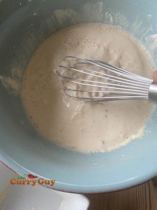 adding water to the flour and yoghurt mixture.