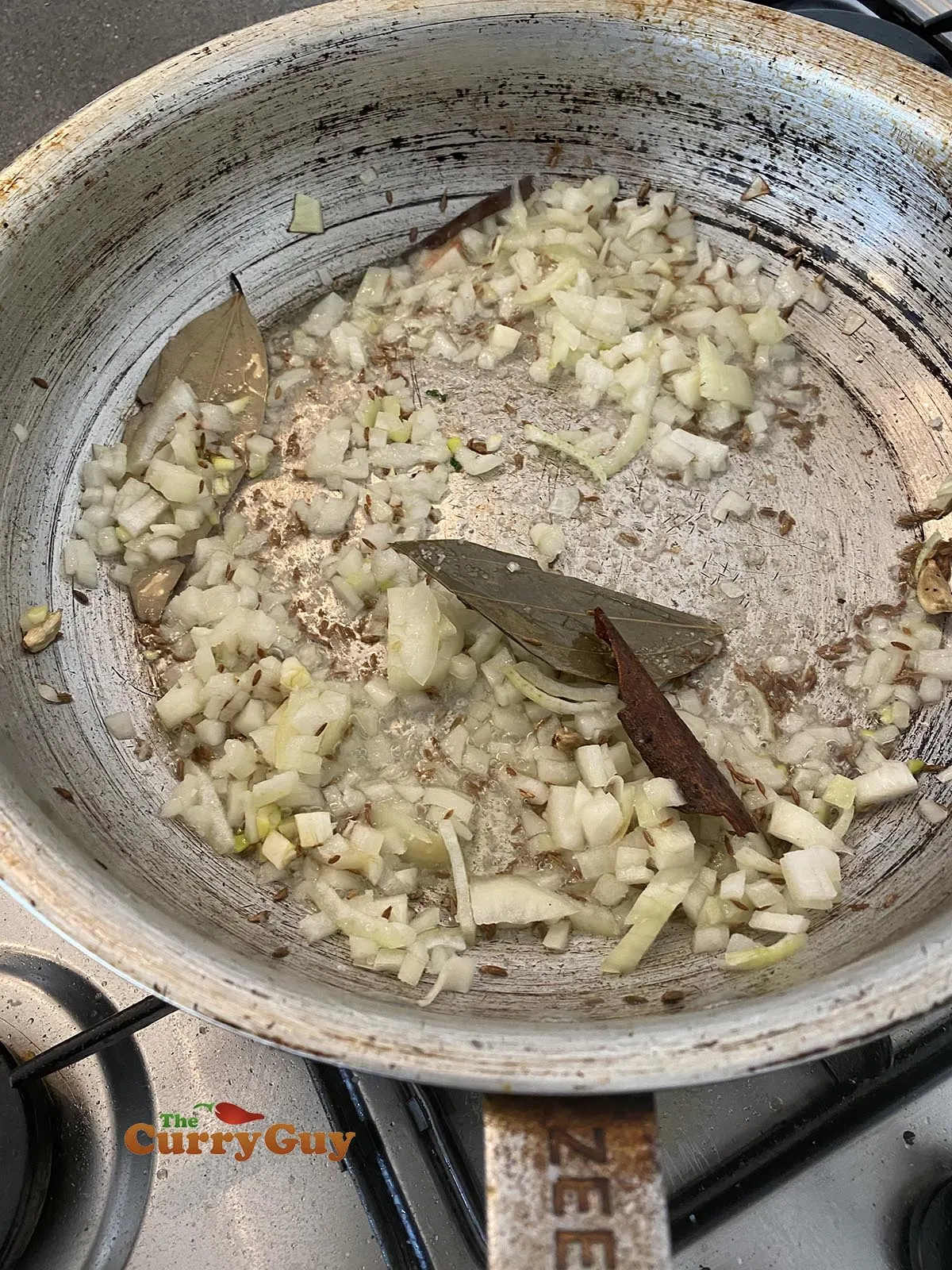 Adding chopped onions to the pan