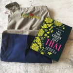 Curry Guy Thai Cookbook with grey apron