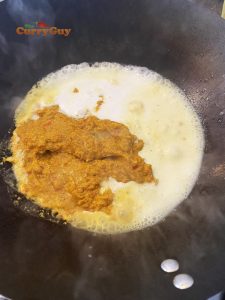 Adding Thai yellow curry paste