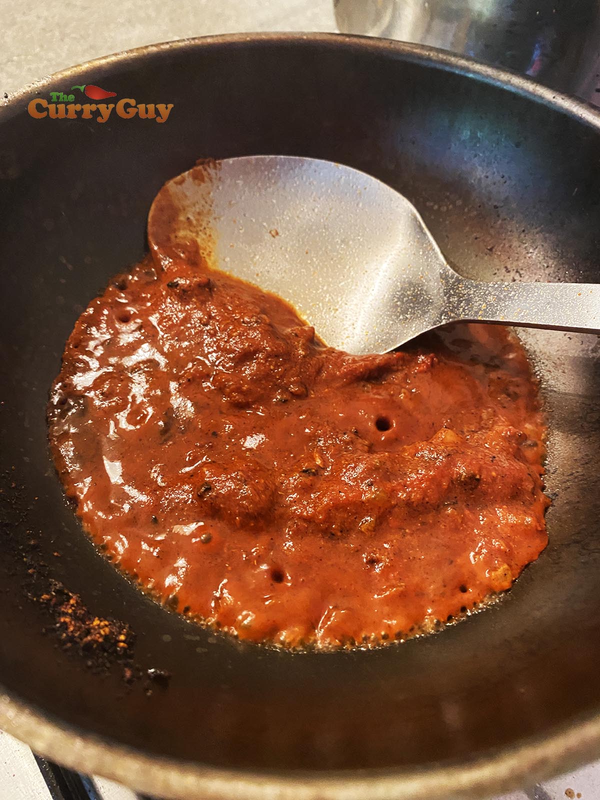 Adding tomato puree.