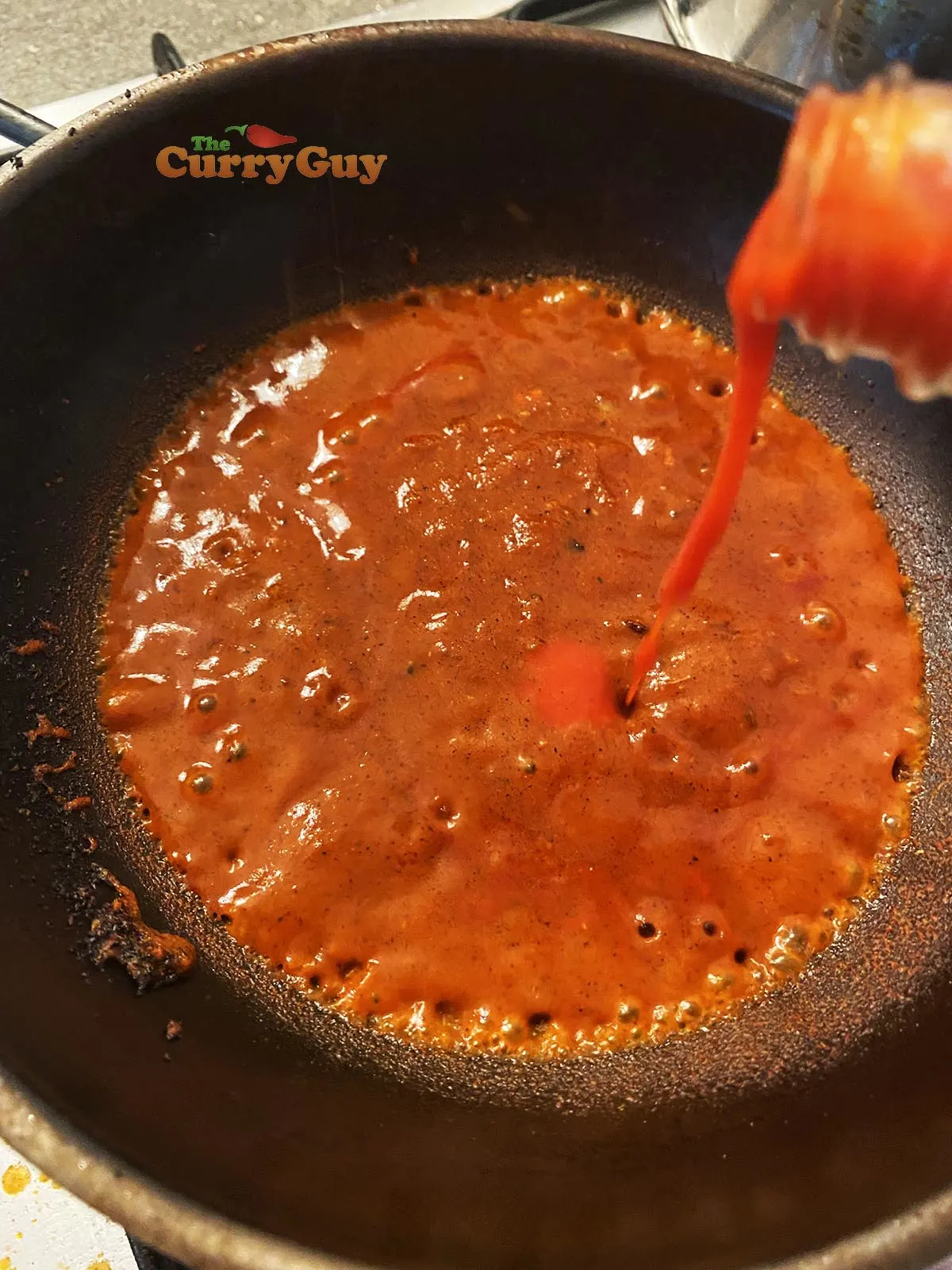 Adding chilli sauce to pan