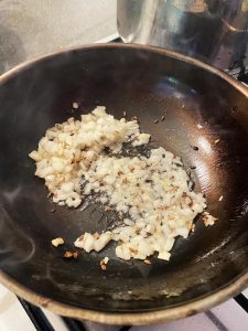 Stirring onions into the pan