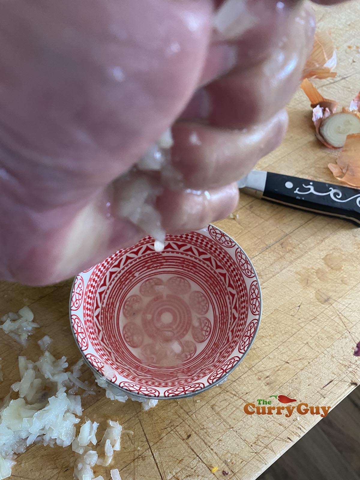 Squeezing moisture from onion.