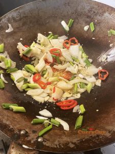 Adding the remaining veggies to the wok