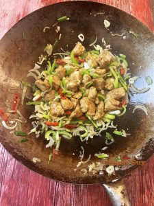 Salt and pepper chicken cooking in wok