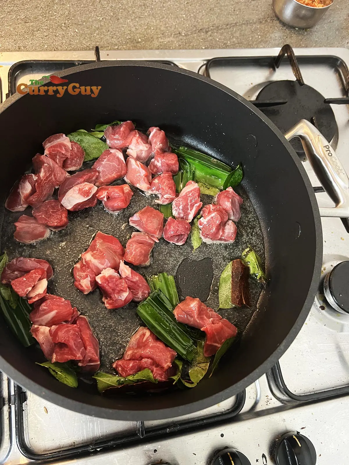 Infusing aromatic and adding lamb to pan