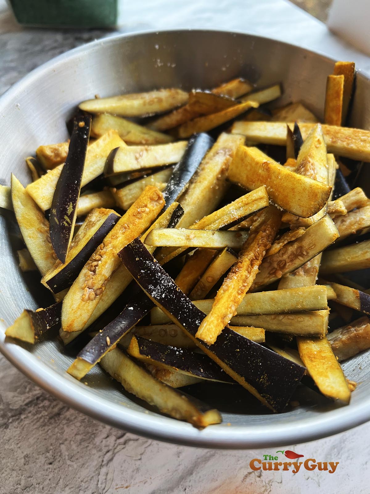 Eggplant chips seasoned with salt and ground turmeric.