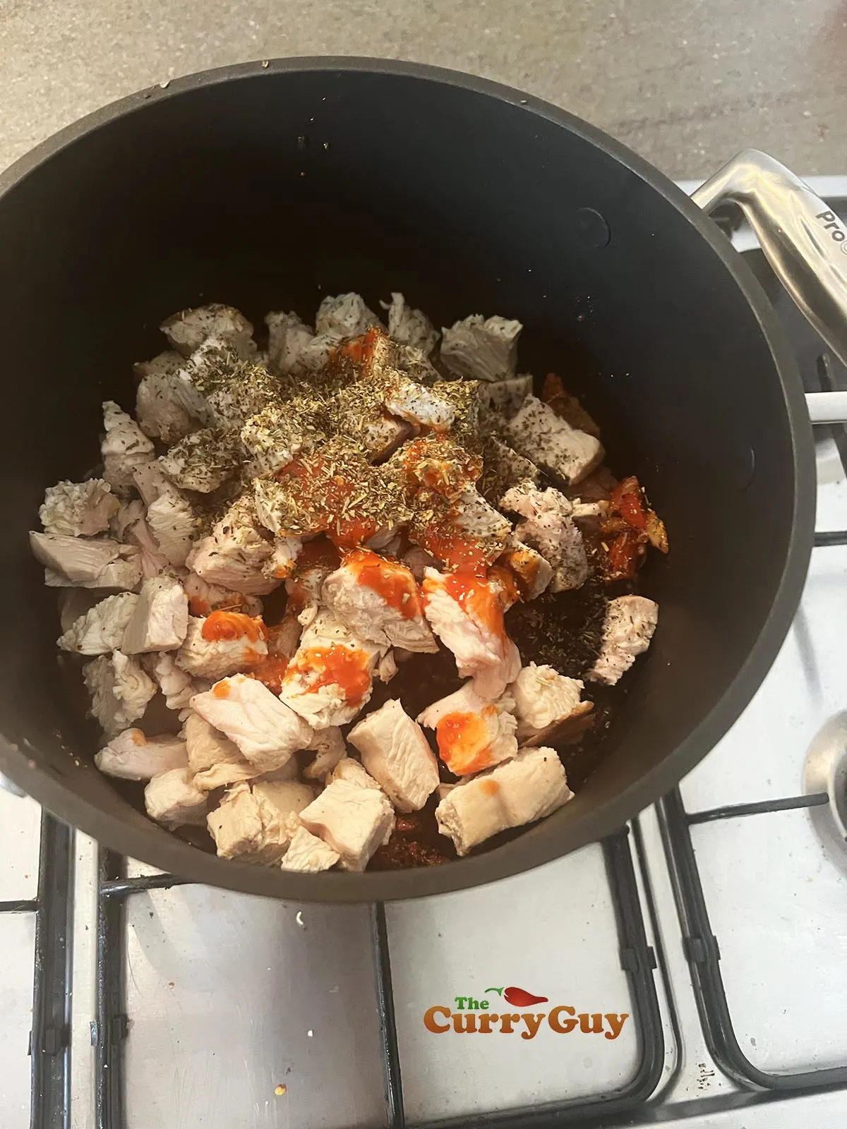 Adding turkey and hot sauce to pan