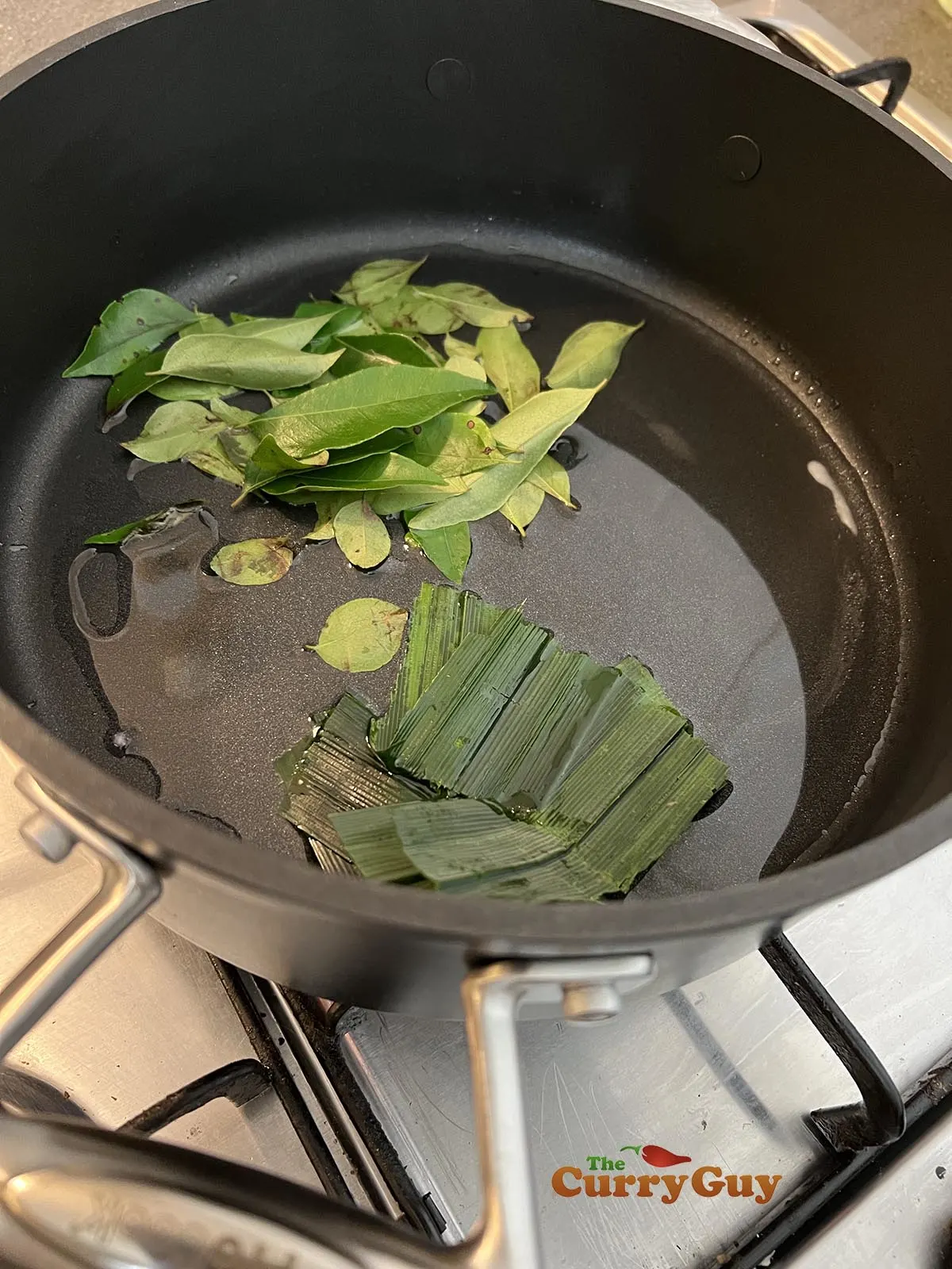 Infusing curry leaves and pandan leaves into oil