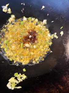 Adding aromatic ingredients to wok