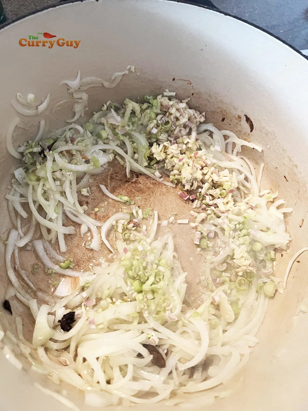 Adding lemongrass and garlic to pan