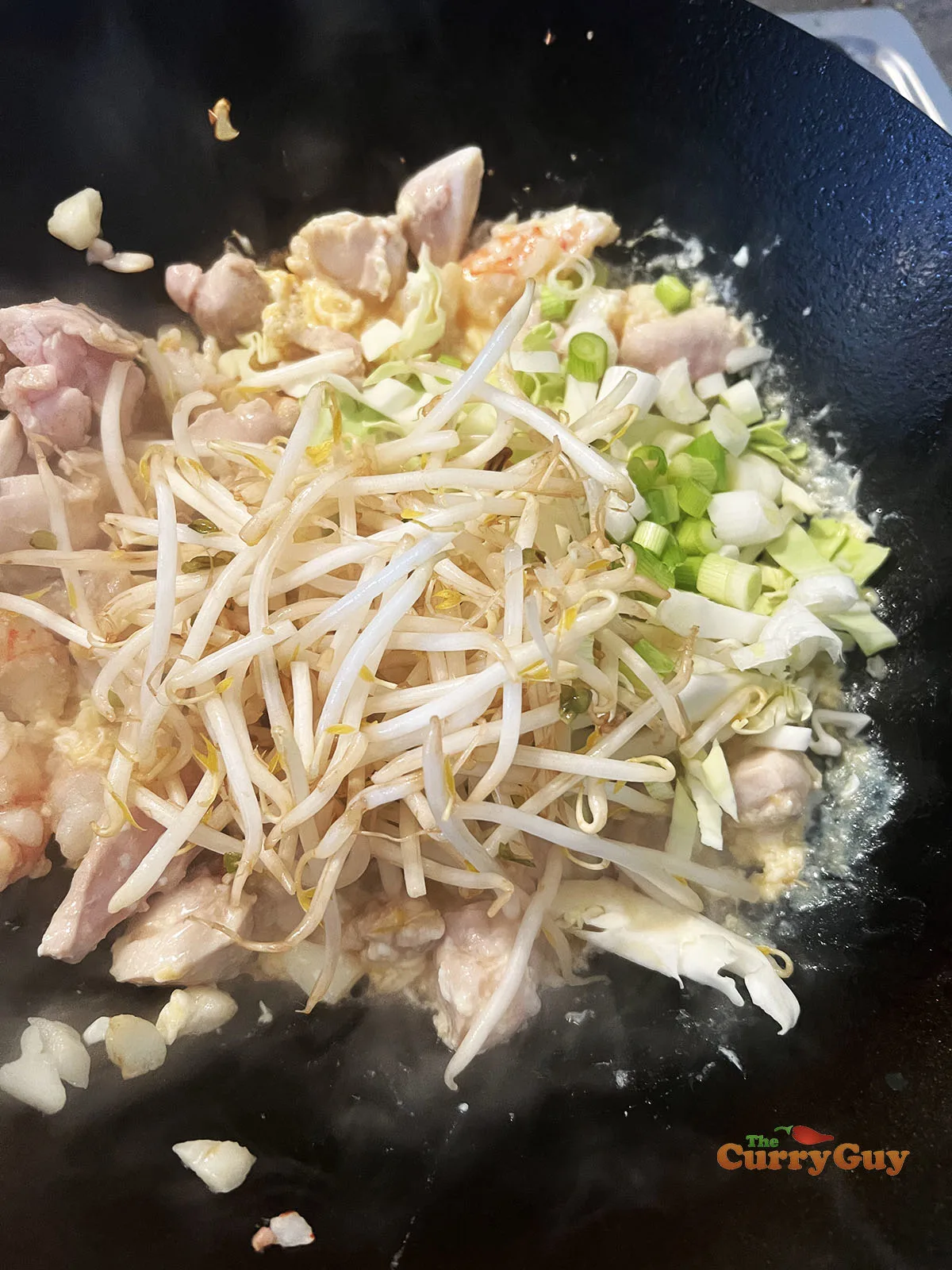 Adding veggies to the wok