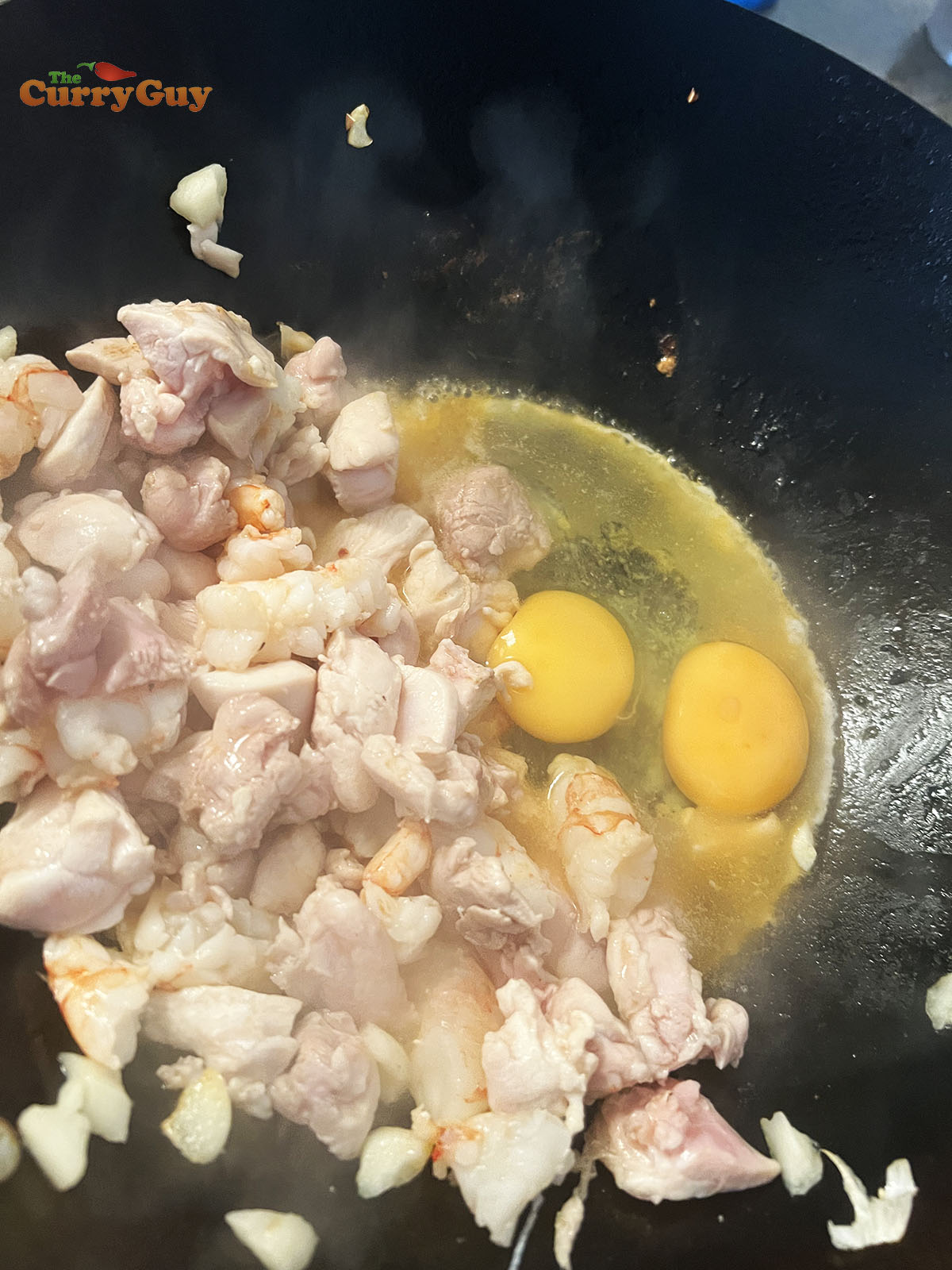 Adding eggs to the wok