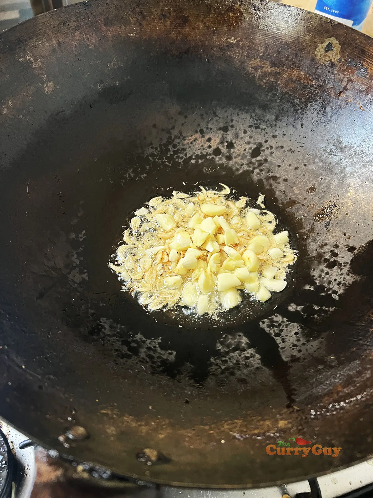 Adding dried shrimp and garlic to wok