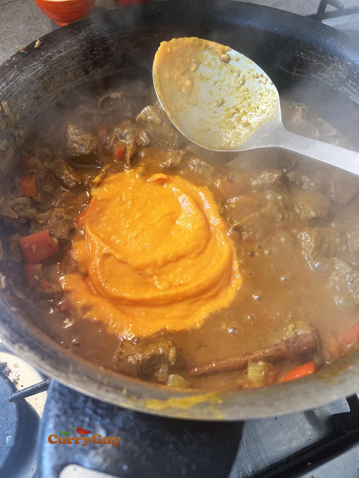 Adding smooth sauce to the pan.