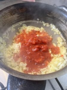 Adding tomatoes to the pan