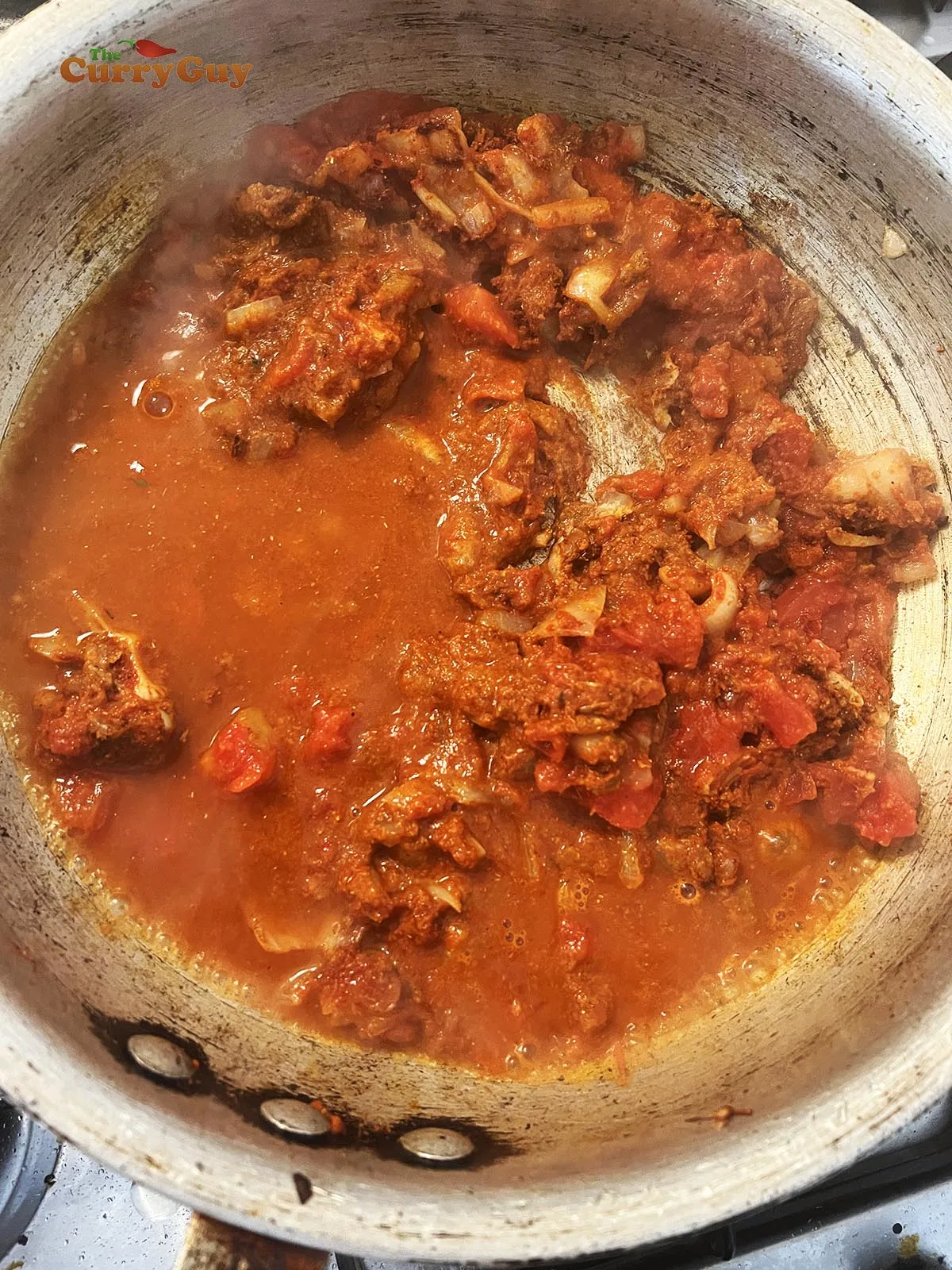 Adding chopped tomatoes and water/stock to the pan