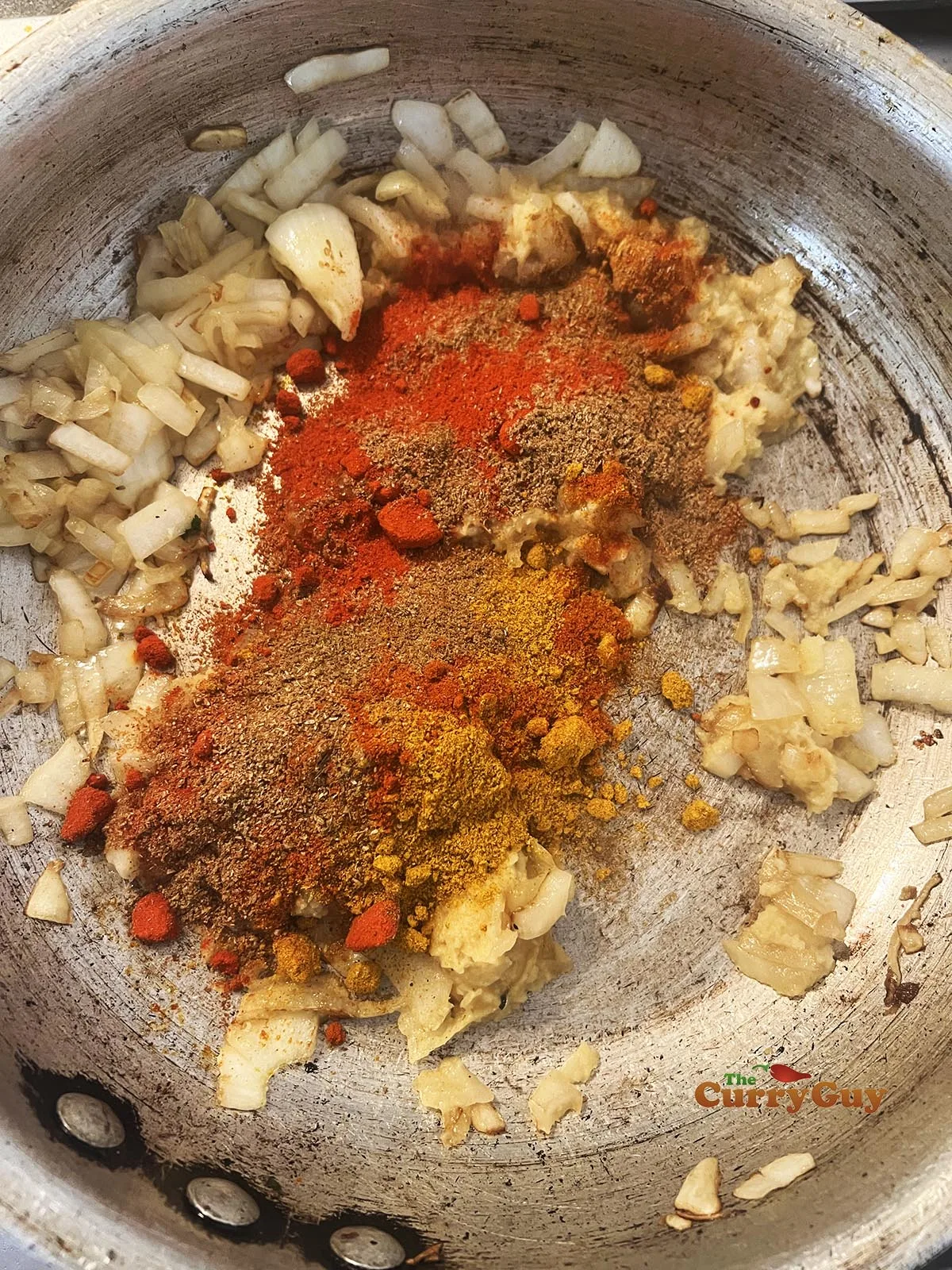 Adding ground spices to the pan