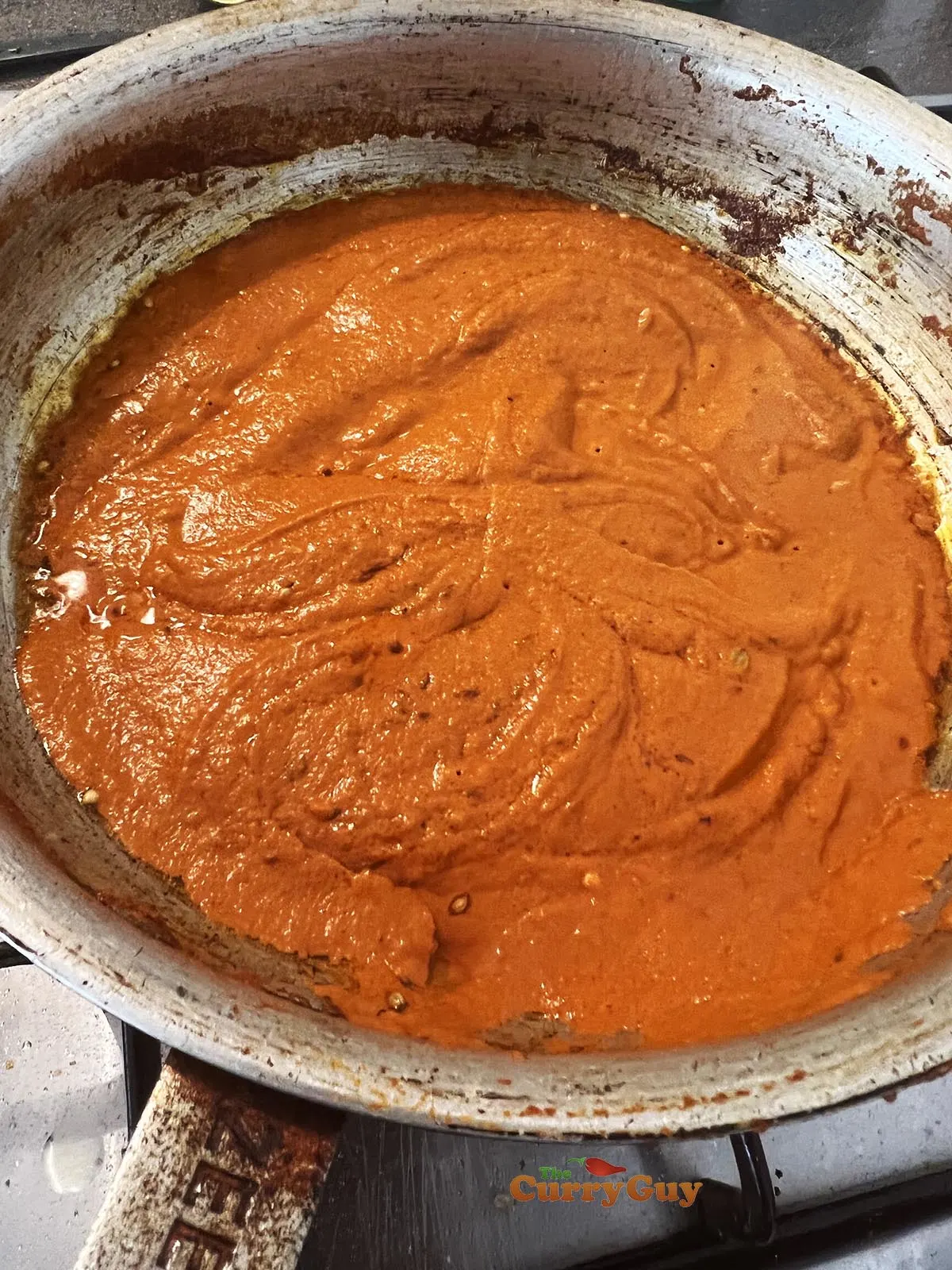 Adding blended sauce to pan.