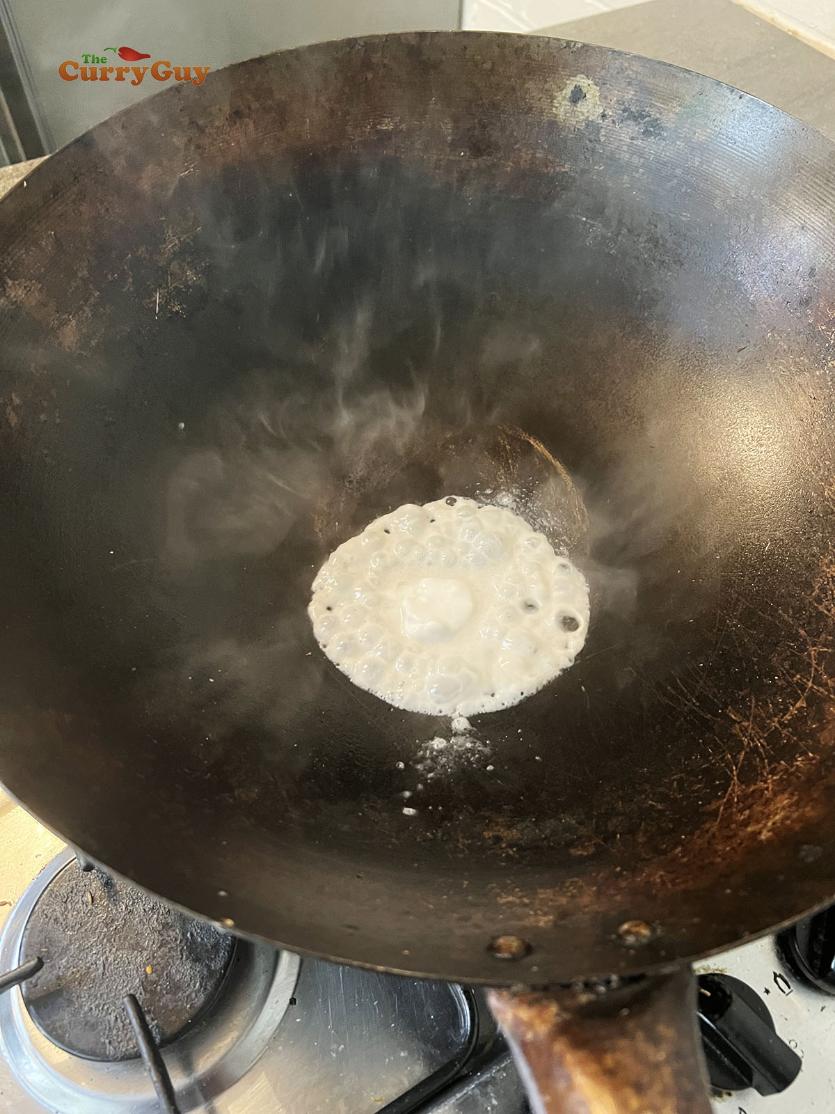 Heating coconut milk in wok