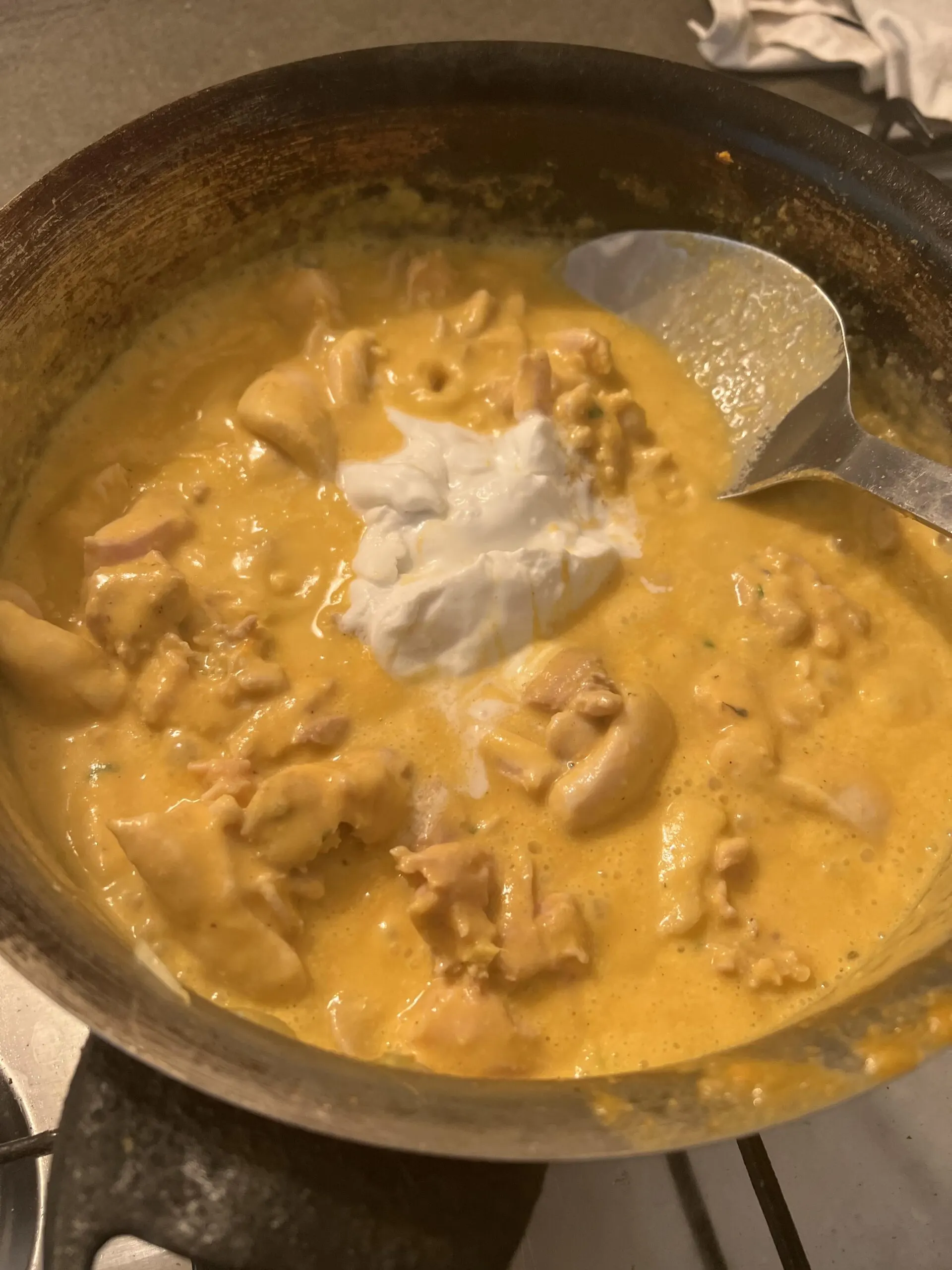 Adding coconut cream to the curry