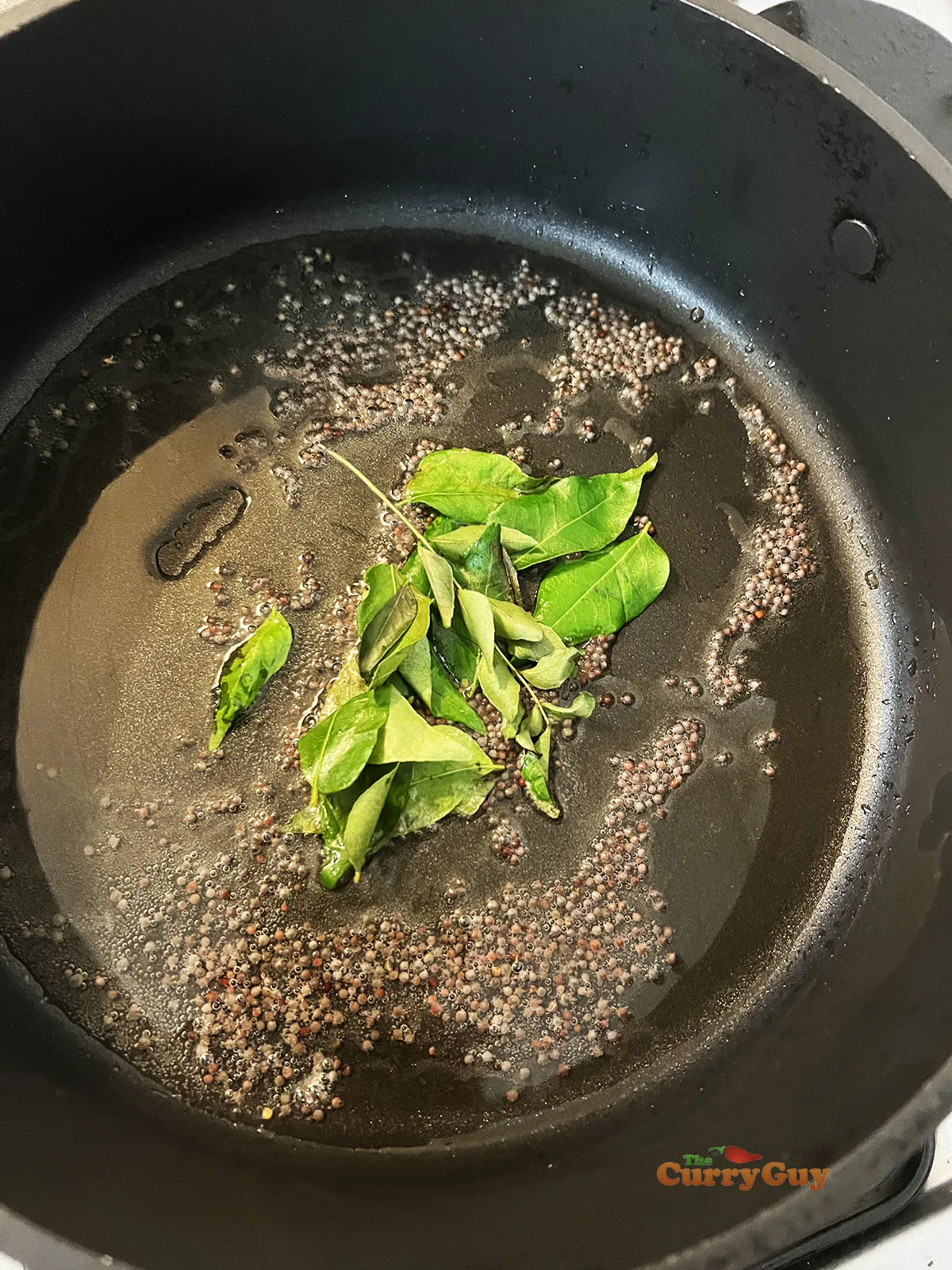 Frying mustard seeds and curry leaves