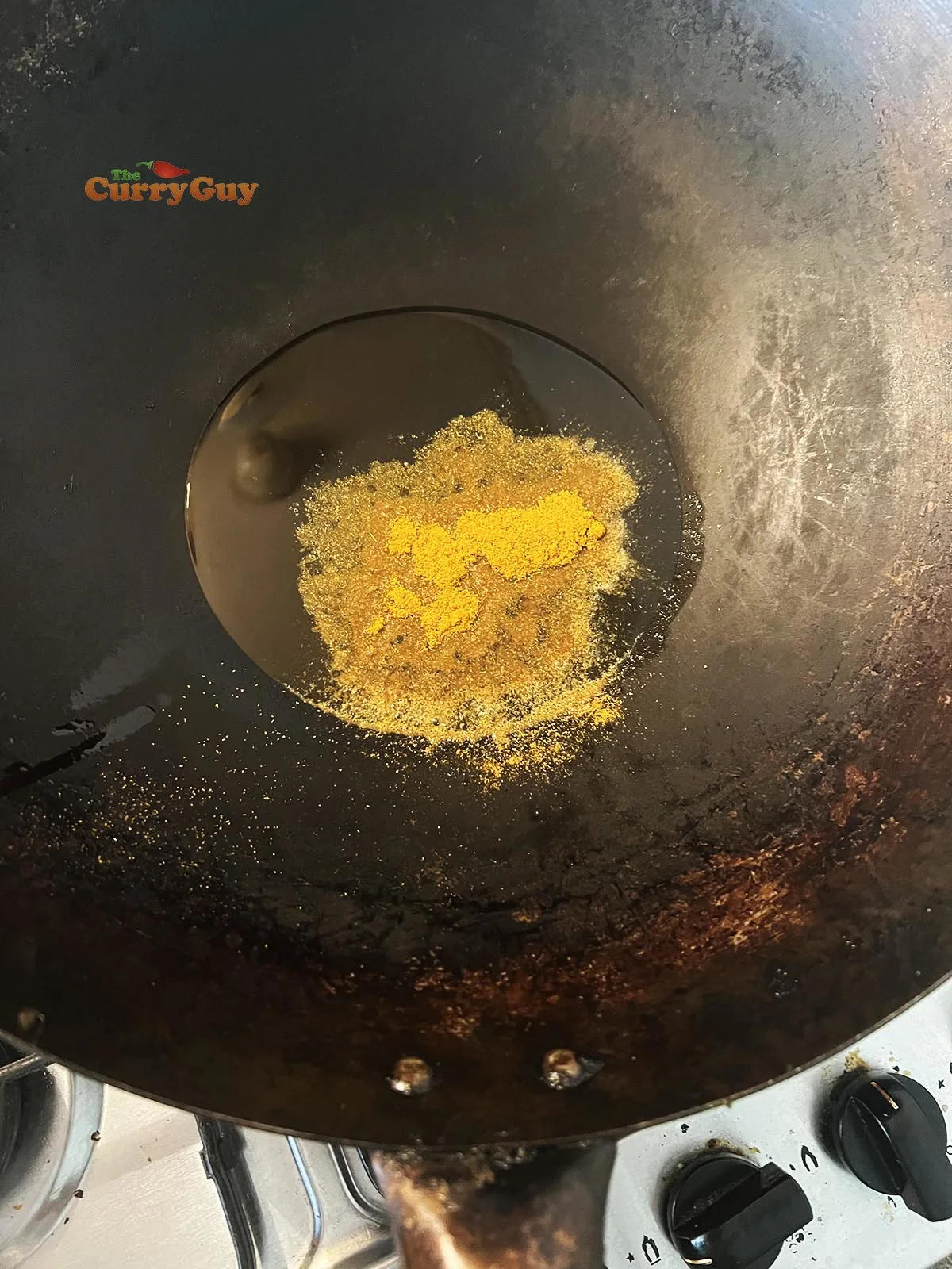Frying curry powder in a wok