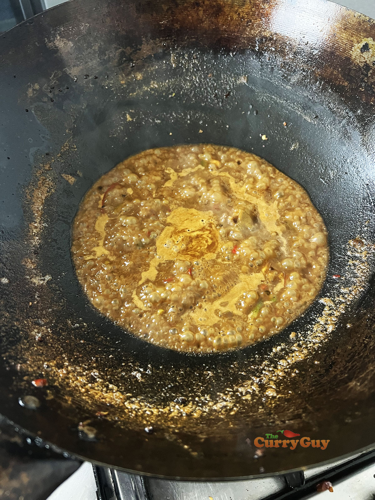 Adding remaining sauce ingredients to the wok