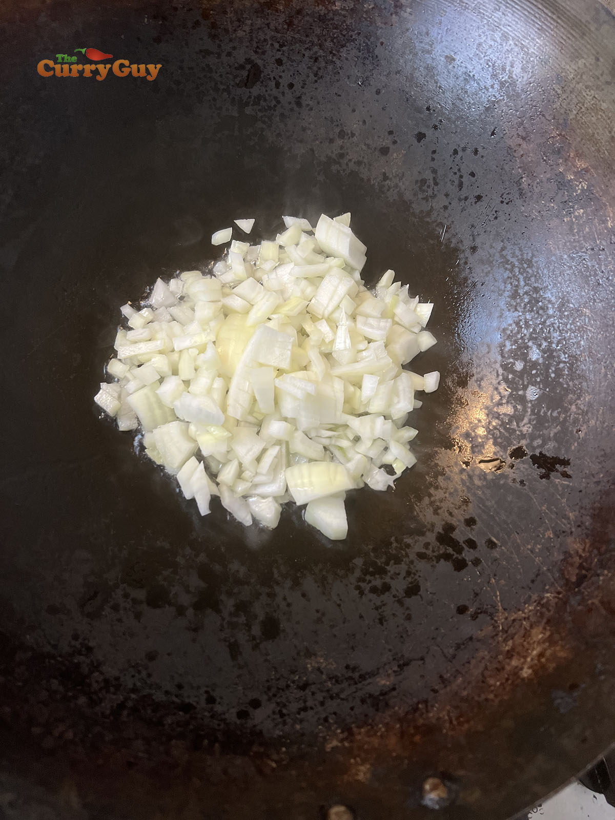 Frying onions in a hot wok.