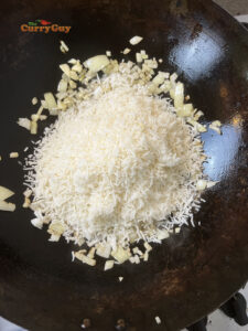 Adding cold cooked rice to the wok