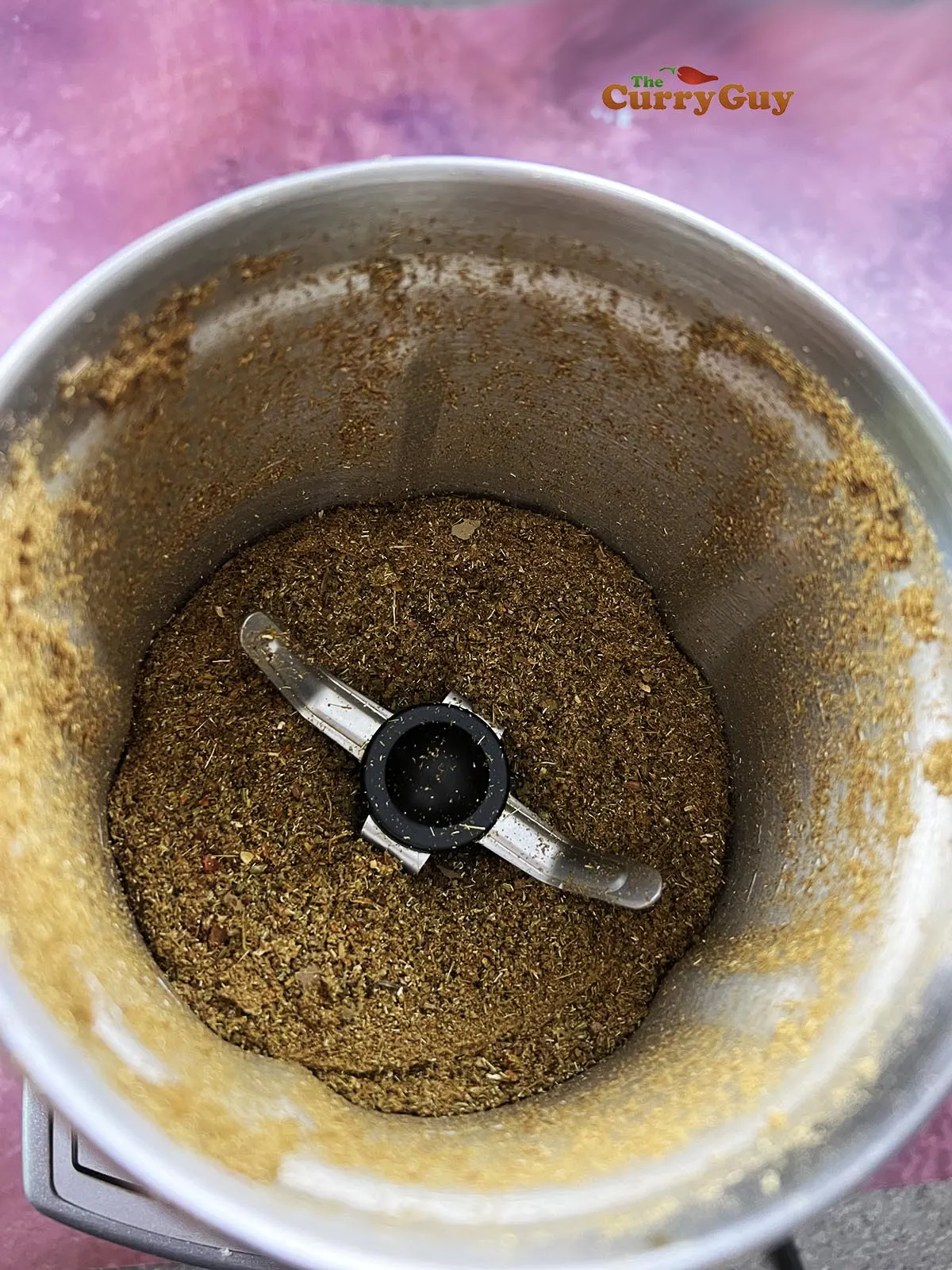 Grinding the spices to a powder.