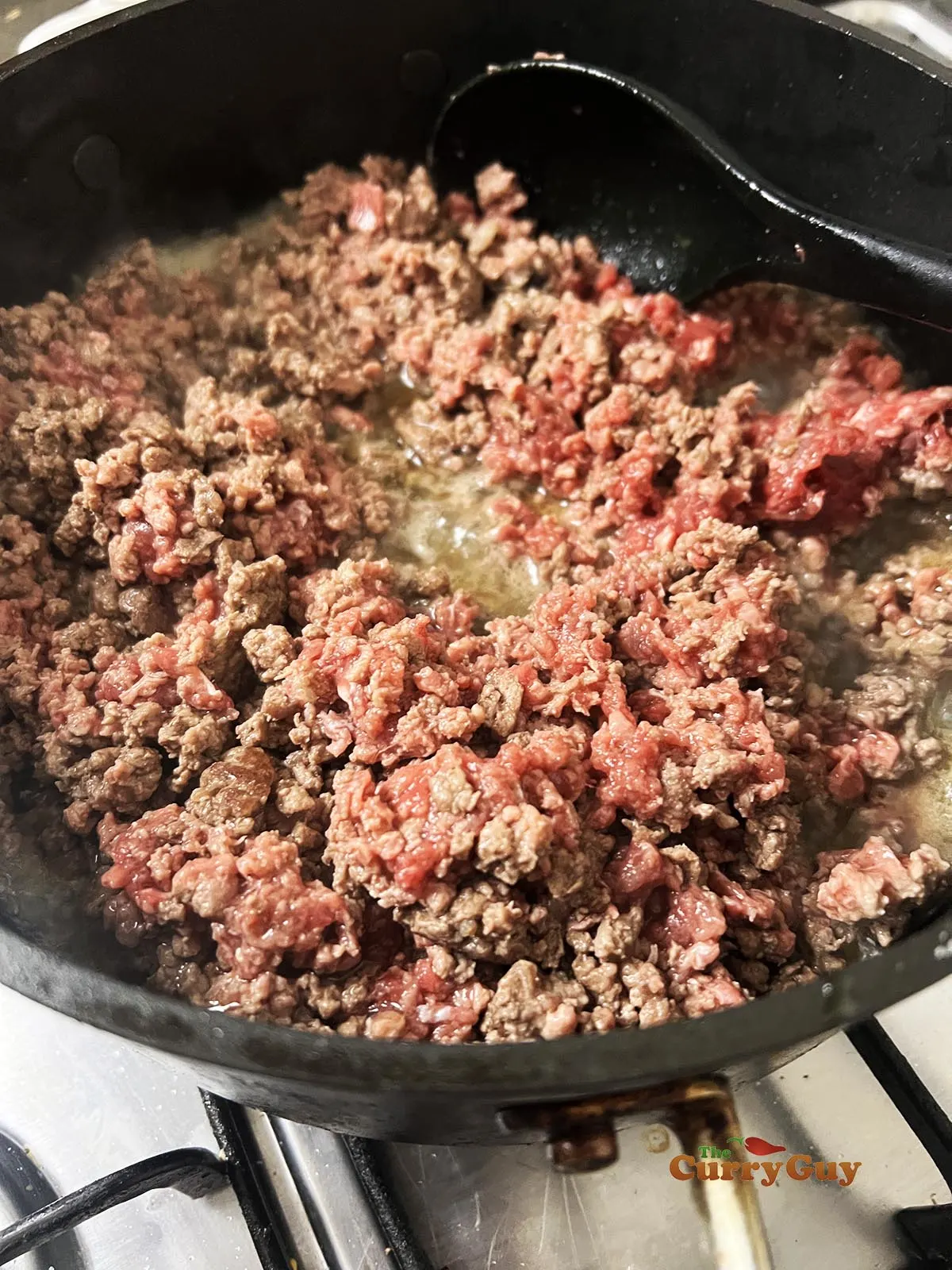 Browning the beef in a pan.