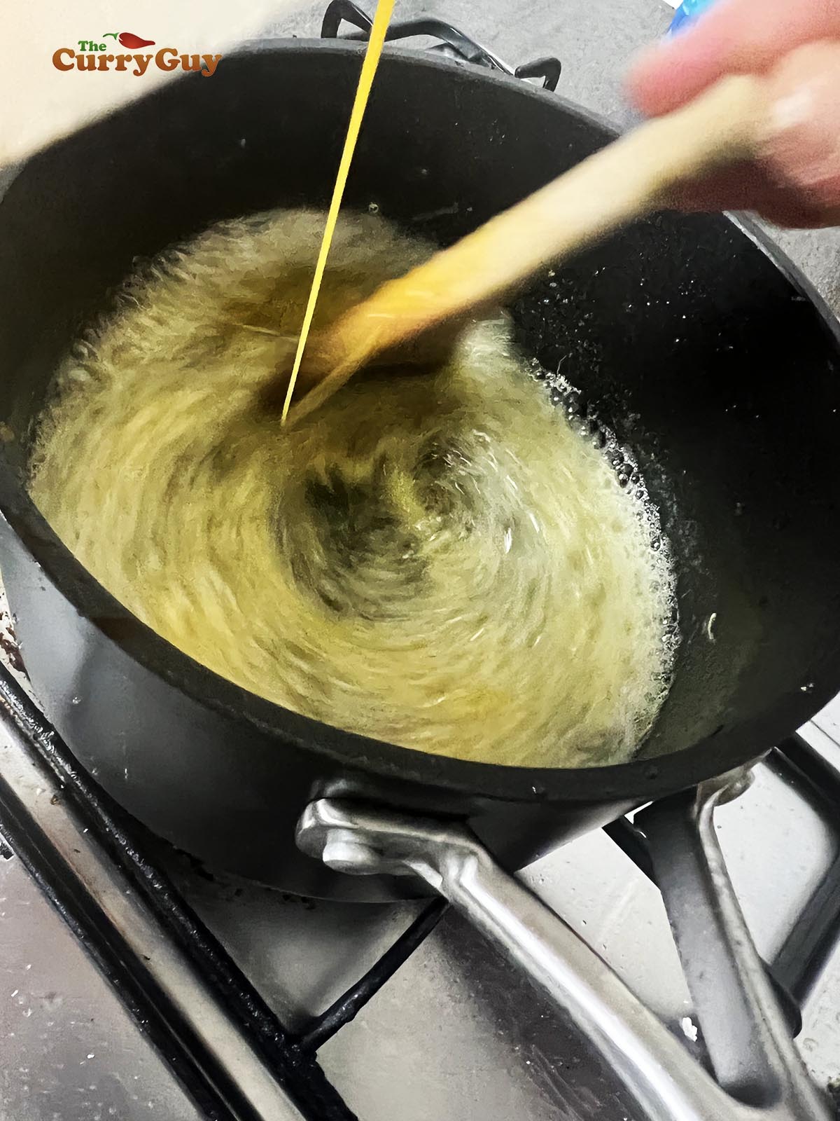 Adding egg yolk to the the butter and oil mixture.