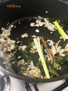 Adding fresh aromatic ingredients to the pan