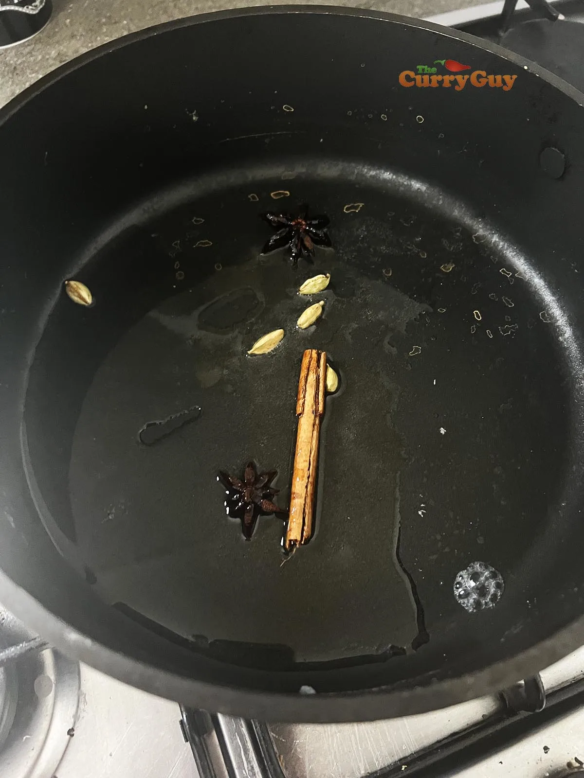 Infusing whole spices into hot oil.