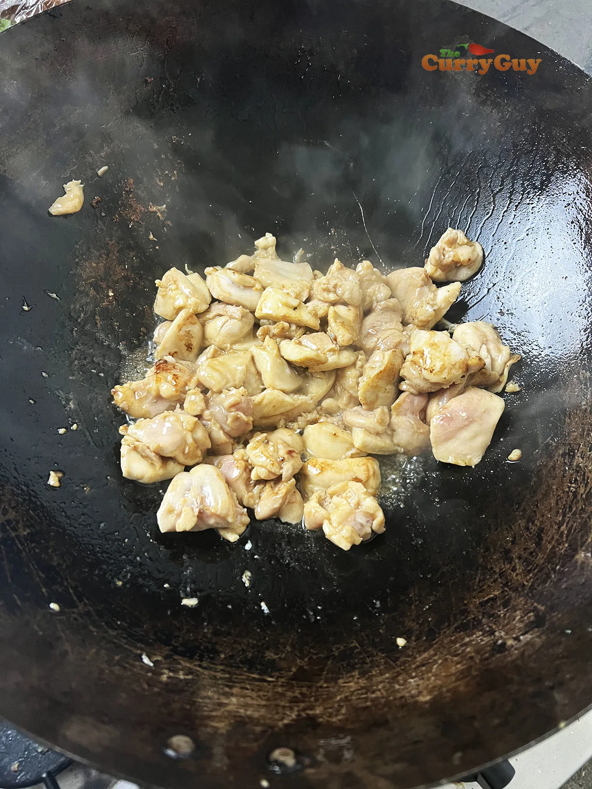 Frying chicken in a wok