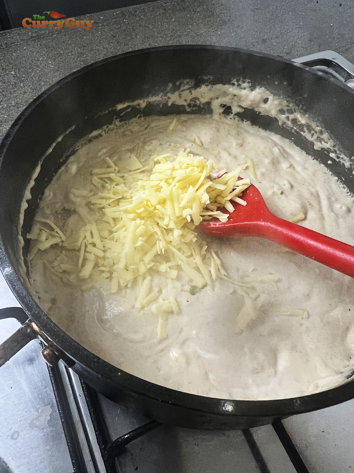 Adding grated cheese to the sauce