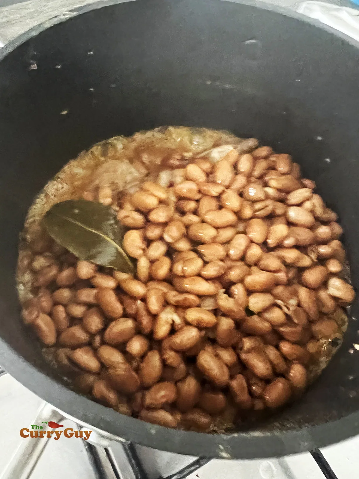 Cooking the beans in pork lard.