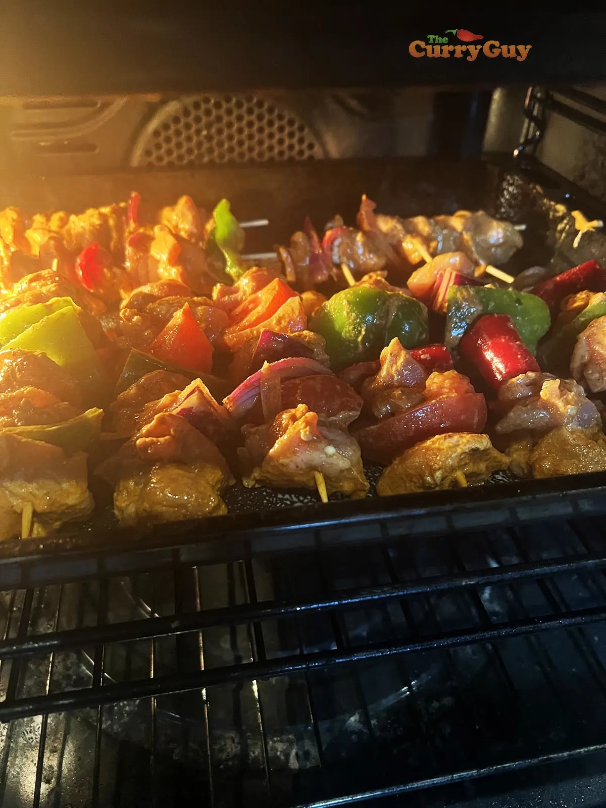 Chicken tikka and vegetables in the oven.