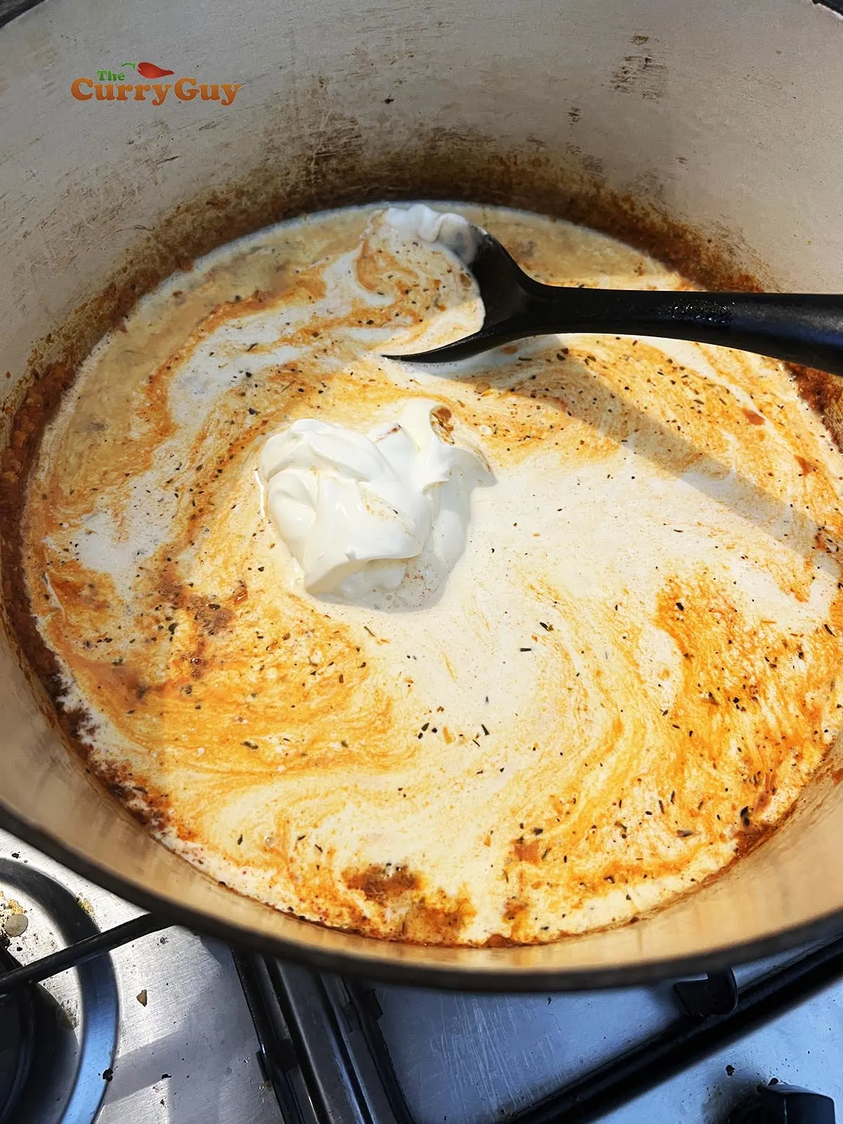 Cream, milk and sour cream added to the pan. 