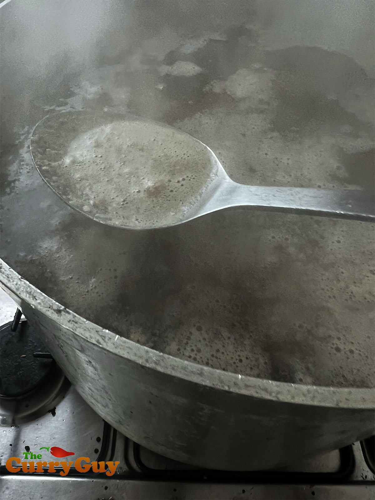 Skimming foam and other impurities off the top of the broth