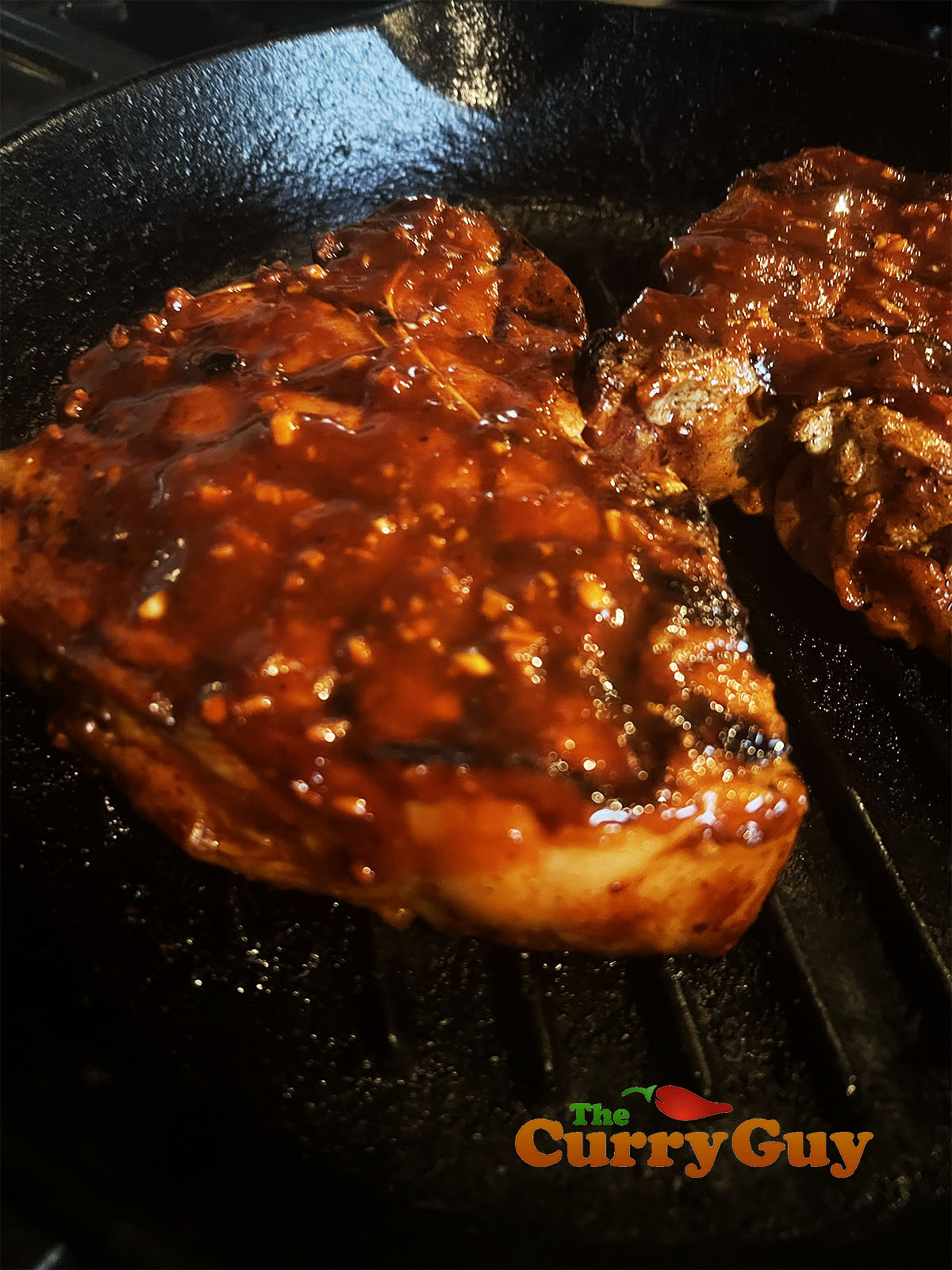 Basting the Korean pork chops with the reserved marinade.